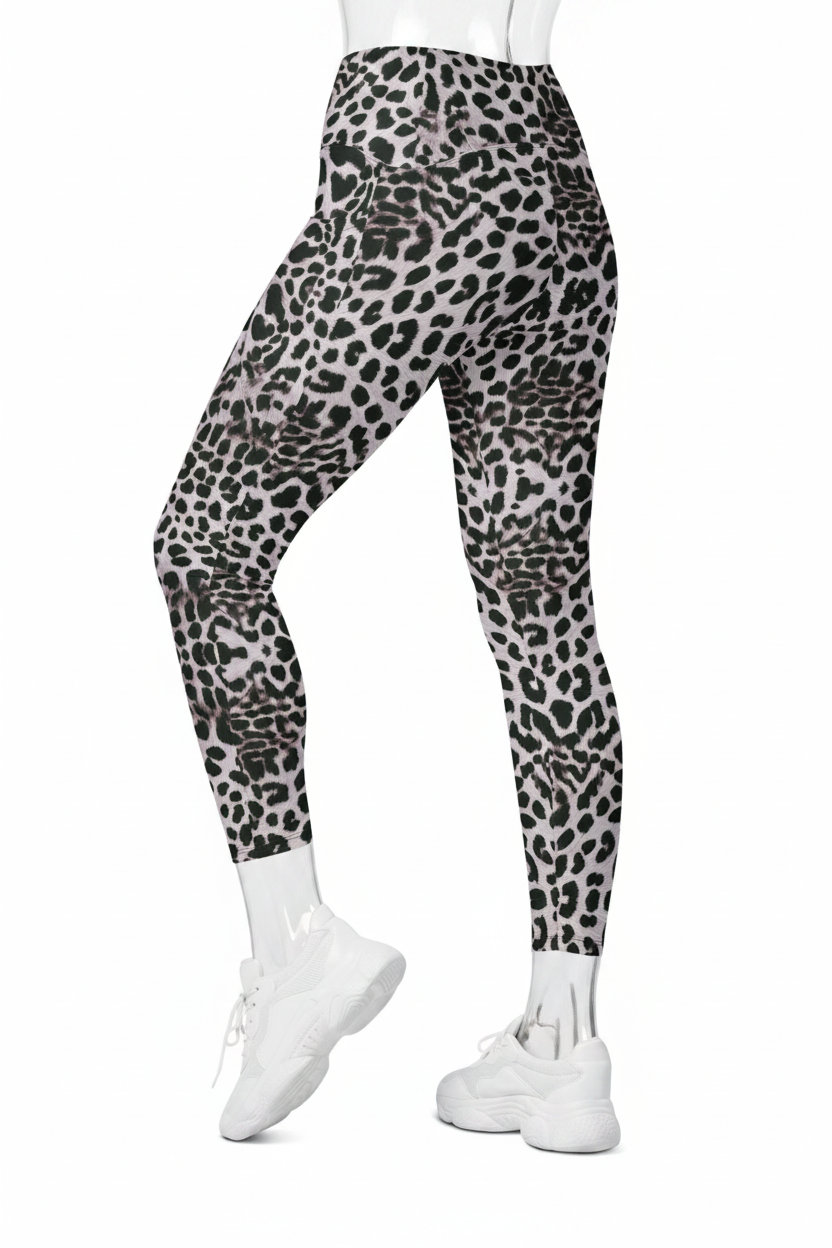 A mannequin modeling high-waisted leggings with a black, gray, and white leopard print pattern, paired with white sneakers against a plain white background.