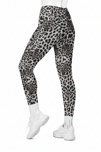 A mannequin modeling high-waisted leggings with a black, gray, and white leopard print pattern, paired with white sneakers against a plain white background.