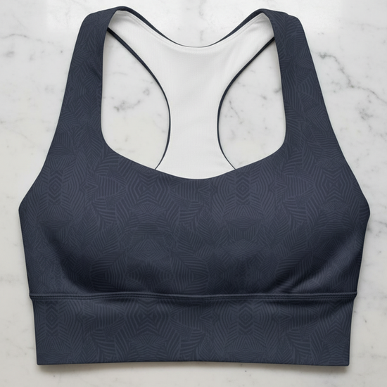 Navy blue sports bra with geometric pattern on a marble surface