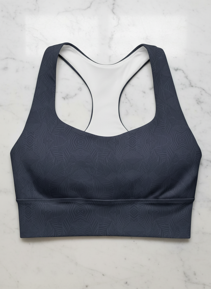 Navy blue sports bra with geometric pattern on a marble surface