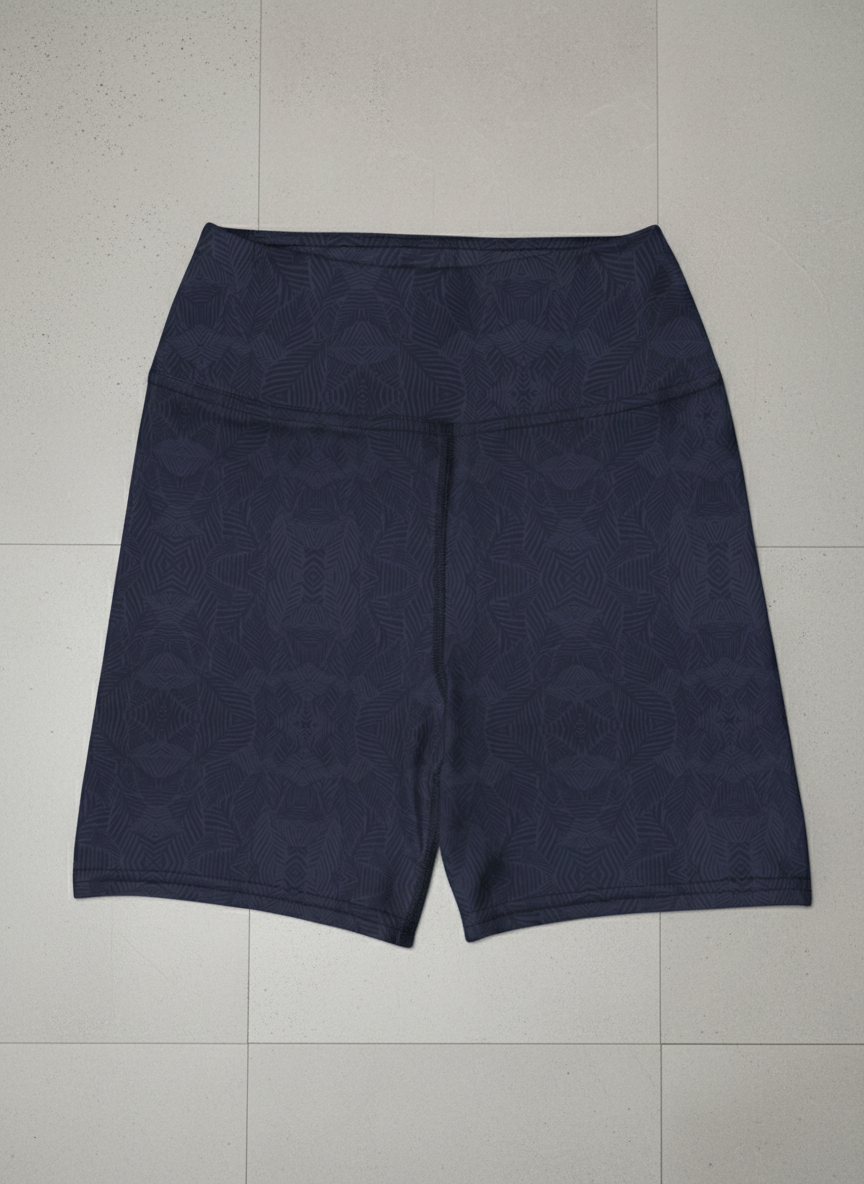 Front view of navy and blue, Shadow leaf Yoga shorts with gentle leaf pattern on a light grey background