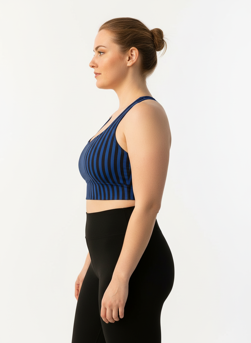 Woman wearing a blue striped sports bra and black leggings on a white background