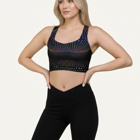 Woman wearing a black sports bra with colorful patterns on a white background