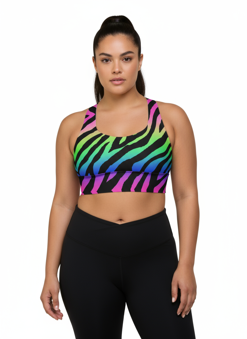Woman wearing a colorful zebra print sports bra and black leggings on a white background
