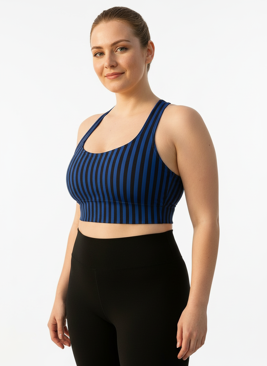 Woman wearing a blue striped sports bra and black leggings on a white background