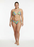 Woman wearing a colorful floral bikini on a white background