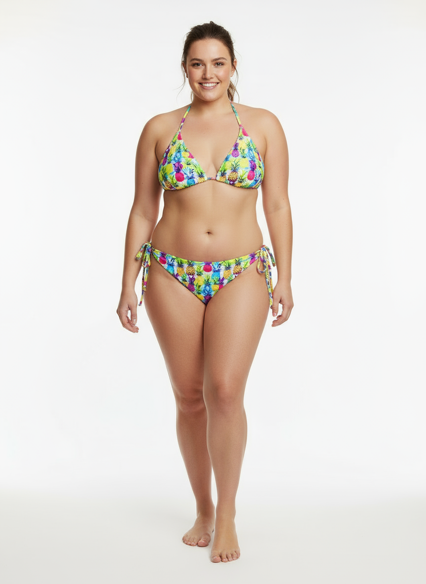 Model wearing Pixie & Sherbet floral recycled string bikini with halter top and tie‑side bottoms, featuring vibrant multicolour print.