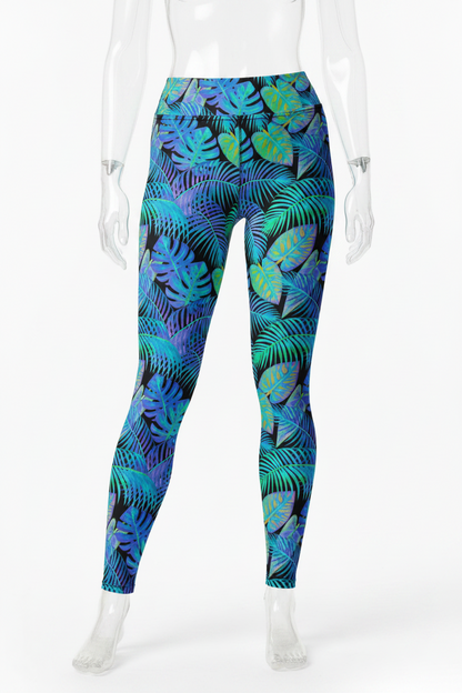 A mannequin modeling high-waisted leggings with a tropical leaf print in shades of blue, teal, green, and purple on a black background, shown against a plain white studio backdrop.