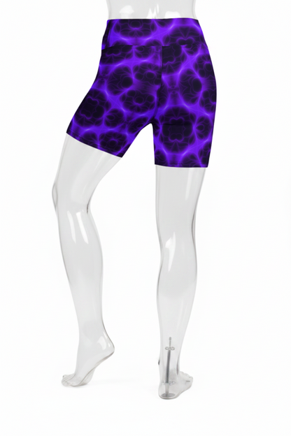 Rear view of a mannequin wearing high-waisted biker shorts with a purple and black abstract organic pattern, shown against a plain white background.