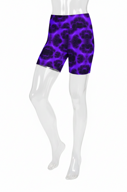 A mannequin wearing high-waisted biker shorts with a vibrant purple and black abstract organic pattern, shown from the waist down on a plain white background.