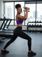 Woman exercising with dumbbells in a gym setting
