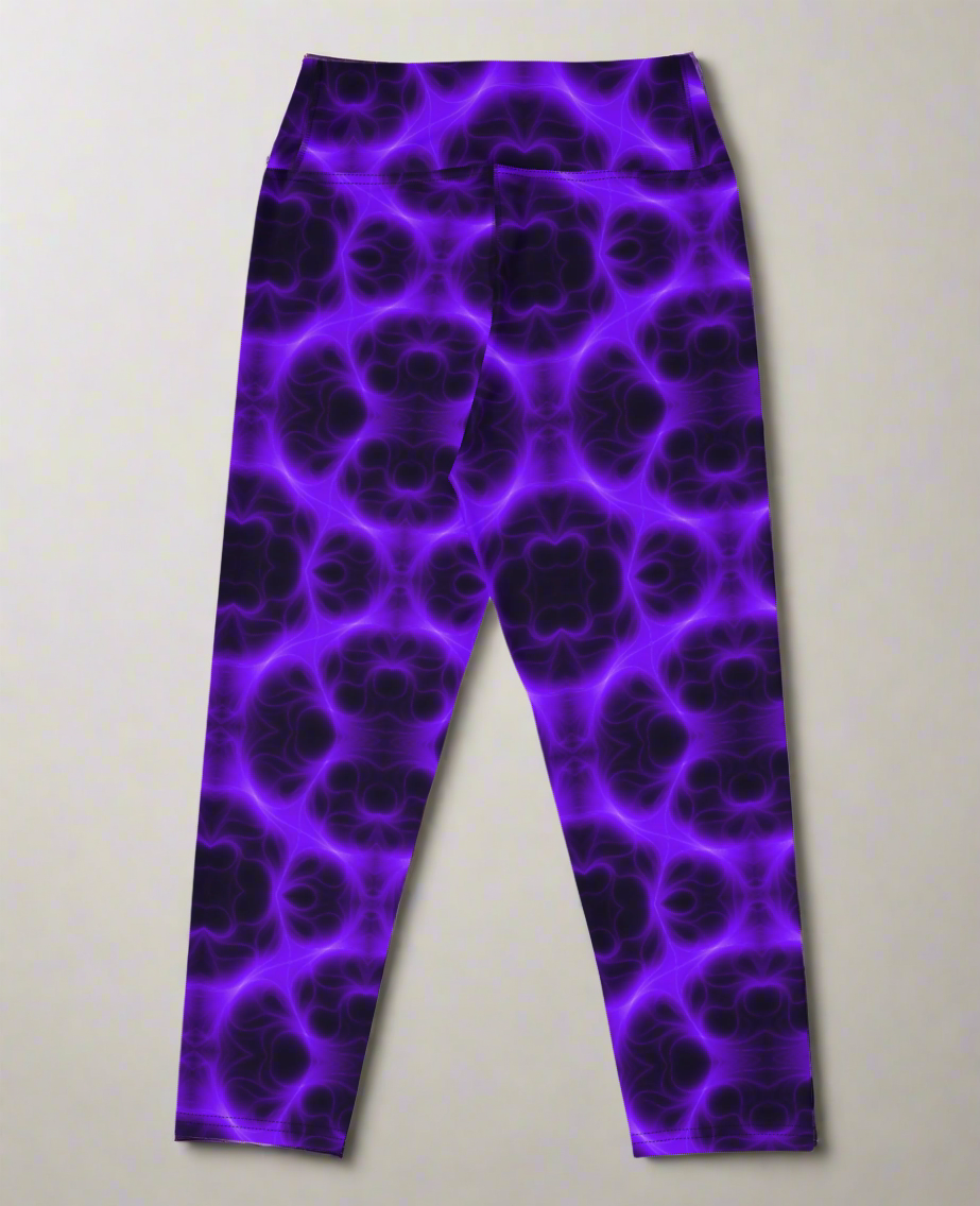 Back view, flat lay of Violet Voltage Yoga Capri leggings featuring a bold purple and black kaleidoscope pattern; displayed on a neutral surface to highlight the vivid, symmetrical design.
