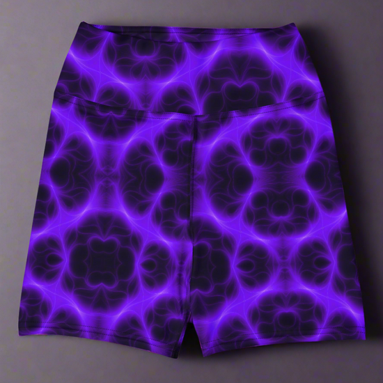 High‑waisted Violet Voltage yoga shorts with vivid purple and black symmetrical abstract pattern, featuring glowing electric‑inspired design on dark background.