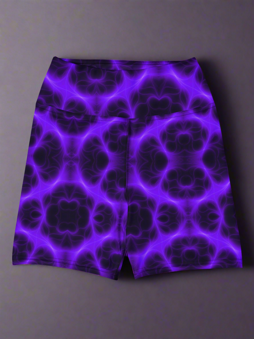 High‑waisted Violet Voltage yoga shorts with vivid purple and black symmetrical abstract pattern, featuring glowing electric‑inspired design on dark background.