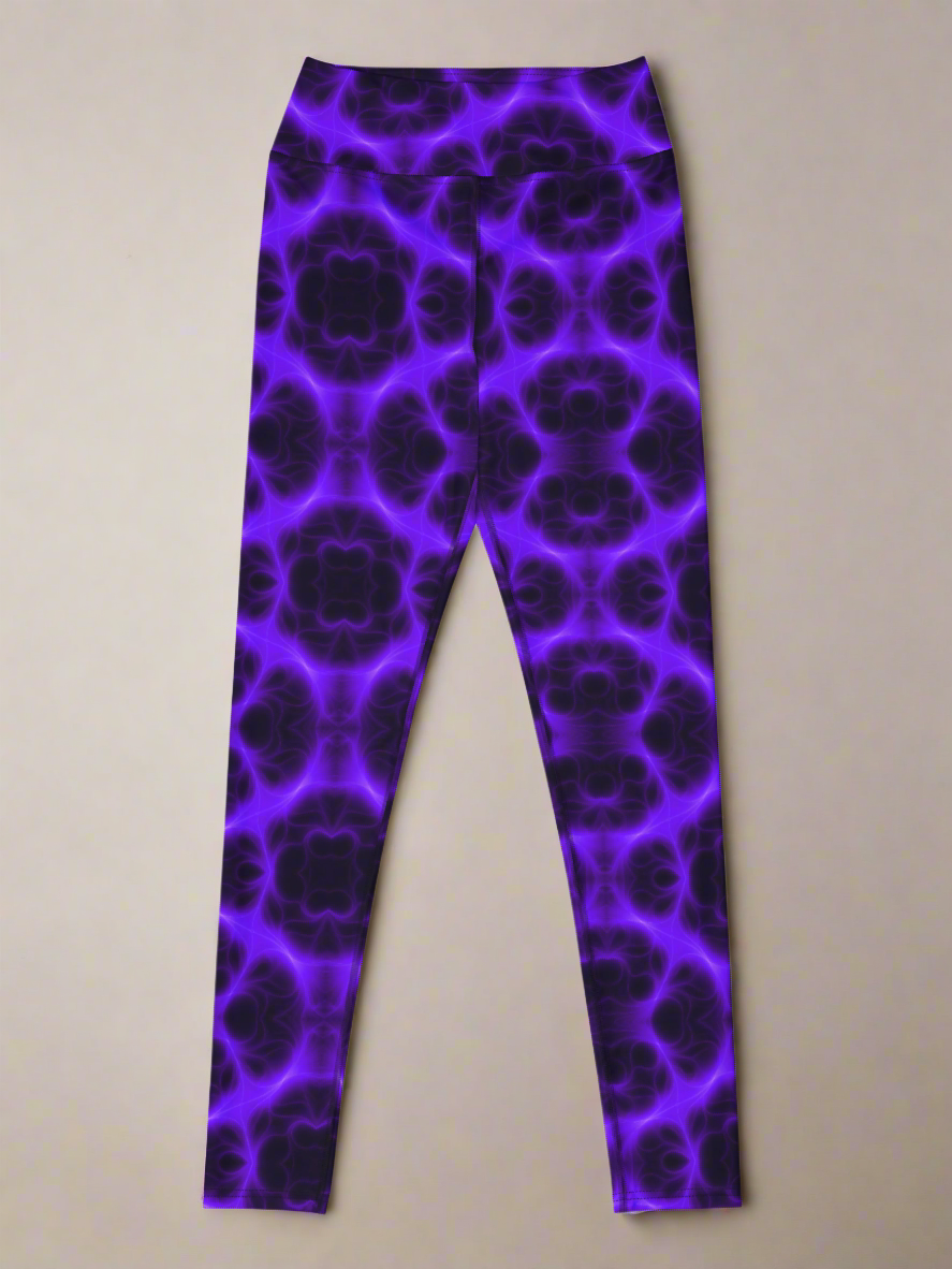 Front flat‑lay view of Violet Voltage Yoga Leggings, featuring a bold symmetrical pattern in shades of purple and black. Kaleidoscopic, floral‑inspired design with repeating circular motifs, displayed against a neutral background.