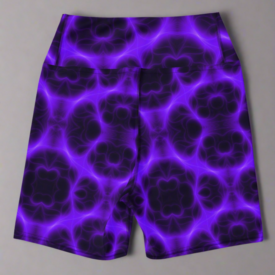 Back view of high‑waisted Violet Voltage yoga shorts with vivid purple and black symmetrical abstract pattern, featuring glowing electric‑inspired design on dark background.