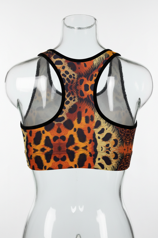 A sports bra with a symmetrical leopard print design in orange, black, and beige, featuring black trim and white inner cups, shown against a plain white background.