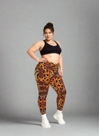 Person wearing leopard print leggings and black sports bra on a gray background